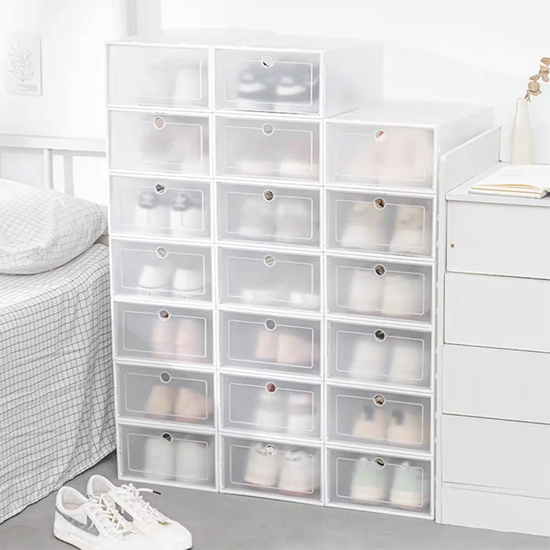 White foldable Shoe Box Storage Organizer holding shoes in the compartments in a bedroom